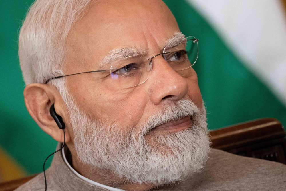 India's Prime Minister Narendra Modi looks on before a meeting with senior officials and CEOs of American and Indian companies, in the East Room the White House in Washington, DC, on June 23, 2023. (Photo by Brendan Smialowski / AFP)