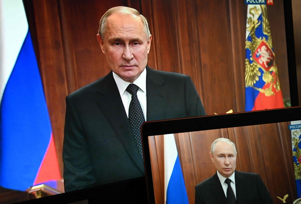 This photograph shows Russian President Vladimir Putin, seen on screens, making a statement in Moscow, on June 24, 2023 as Wagner fighters stage rebellion.  Photo by Pavel Bednyakov / SPUTNIK / AFP