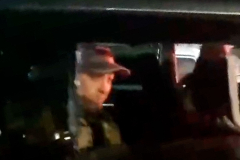 This video grab taken from handout footage posted late on June 24, 2023 on the Telegram channel @rstv01 shows Yevgeny Prigozhin looking on from a car as he leaves the headquarters of the Russian southern military district in the city of Rostov-on-Don. Wagner mercenaries were headed back to base on June 25, 2023, after Russia's President Vladimir Putin agreed to allow their leader to avoid treason charges and accept exile in Belarus. (Photo by Handout / TELEGRAM / @rstv01 / AFP)