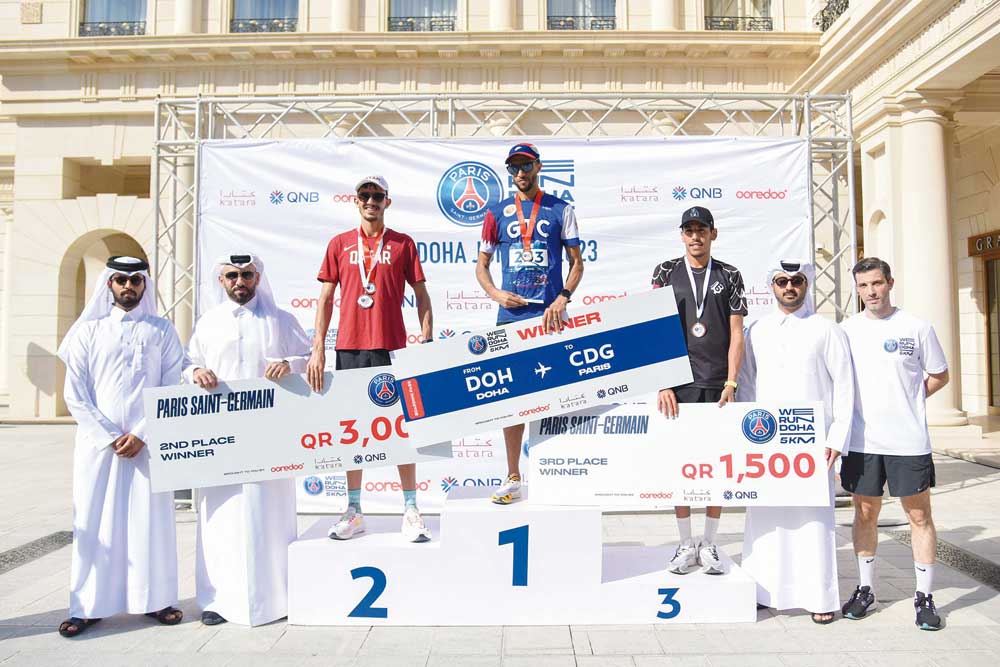 Officials pose for a group photo with 'We Run Doha' winners.