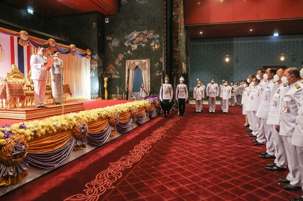 This handout taken and released by Thai Parliament on July 3, 2023 shows Thai King Maha Vajiralongkorn (left), alongside Queen Suthida (2nd left), as he addresses rows of MPs during the official ceremony to open parliament at Thailand's Parliament in Bangkok. (Photo by Thai Parliament / AFP) 