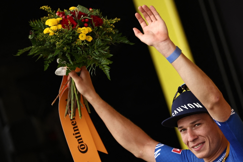 Alpecin-Deceuninck's Belgian rider Jasper Philipsen celebrates his victory on the podium after winning the 4th stage of the 110th edition of the Tour de France cycling race, 182 km between Dax and Nogaro, in southwestern France, on July 4, 2023. (Photo by Anne-Christine POUJOULAT / AFP)
