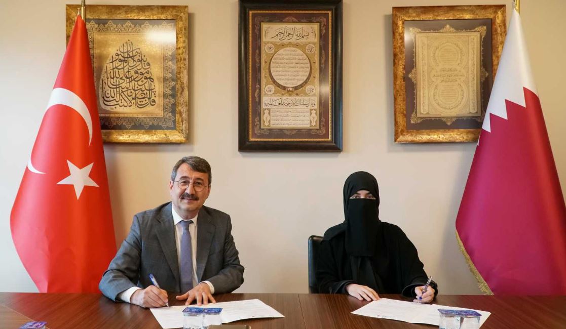 President of Ibn Khaldun University Dr. Atilla Arkan (left) and Dr. Hayat Abdullah Maarafi, Executive Director of QatarDebate, during the signing ceremony.