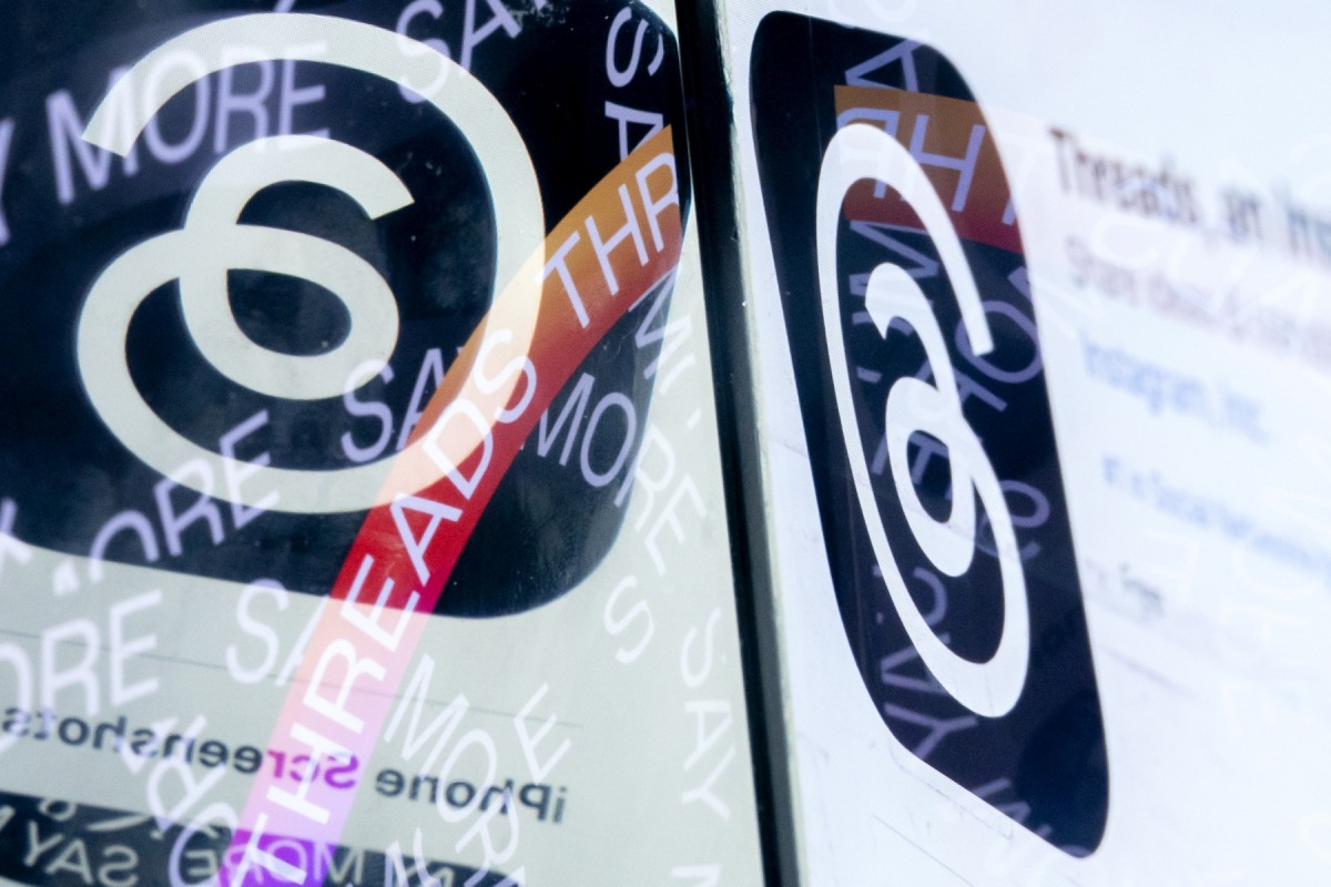 This photo illustration created in Washington, DC, on July 6, 2023, shows the logo for Threads, an Instagram app, next to its page on the App Store. Photo by Stefani Reynolds / AFP