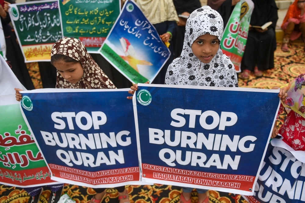 Supporters of Pakistan Markazi Muslim League party take part in an anti-Sweden demonstration in Karachi on July 9, 2023, as they protest against the burning of the Koran outside a Stockholm mosque that outraged Muslims around the world. (Photo by Rizwan Tabassum / AFP)
