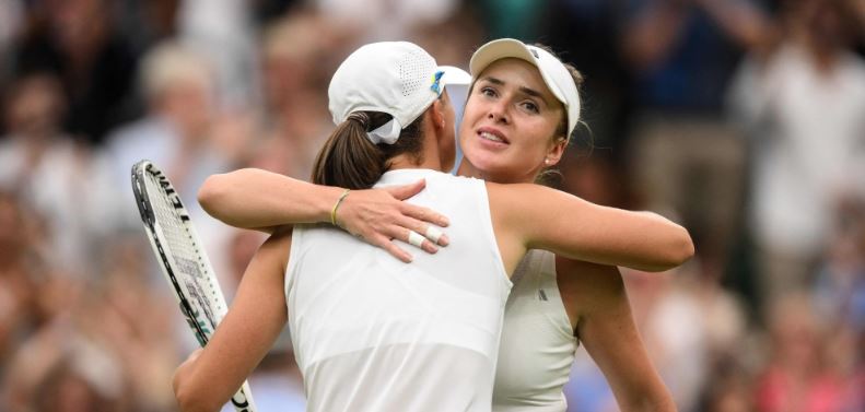 kraine's Elina Svitolina (R) hugs Poland's Iga Swiatek after winning their women's singles quarter-finals tennis match on the ninth day of the 2023 Wimbledon Championships at The All England Tennis Club in Wimbledon, southwest London, on July 11, 2023. (Photo by Daniel LEAL / AFP)