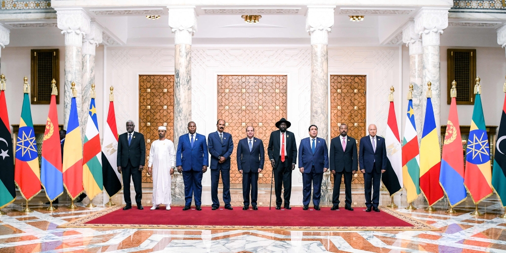 :This handout picture released by the Egyptian Presidency shows (L to R) African Union Commission head Moussa Faki Mahamat, Chad's President General Mahamat Idriss Deby, Central African Republic President Faustin-Archange Touadéra, Eritrea's President Isaias Afwerki, Egypt's President Abdel Fattah al-Sisi, South Sudan's President Salva Kiir Mayardit, the Chairman of the Tripoli-based Libyan Presidential Council Mohamed al-Menfi, Ethiopia's Prime Minister Abiy Ahmed, and Arab League Secretary-General Ahmed Aboul-Gheit posing for a family photo during a regional summit for neighbouring nations impacted by the three-month war between Sudan's rival generals in Cairo on July 13, 2023. (Photo by EGYPTIAN PRESIDENCY / AFP) / === RESTRICTED TO EDITORIAL USE - MANDATORY CREDIT 
