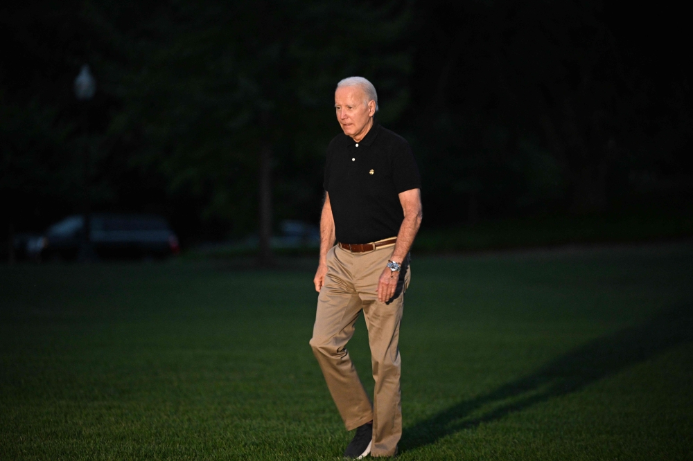 US President Joe Biden walks across the South Lawn upon return to the White House in Washington, DC on July 13, 2023. Biden returned to Washington after a 5-day trip that took him to Britain, Lithuania, and Finland. (Photo by Mandel NGAN / AFP)