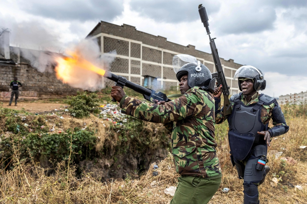 A Kenya Police Officer shoots a tear gas canister to disperse some protesters as they gather to demonstrate in Nairobi, Kenya on July 12, 2023. (Photo by Luis Tato / AFP)

