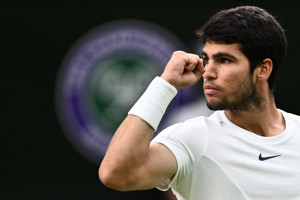 Spain's Carlos Alcaraz reacts as he plays against Russia's Daniil Medvedev during their men's singles semi-finals tennis match on the twelfth day of the 2023 Wimbledon Championships at The All England Lawn Tennis Club in Wimbledon, southwest London, on July 14, 2023. Photo by SEBASTIEN BOZON / AFP
