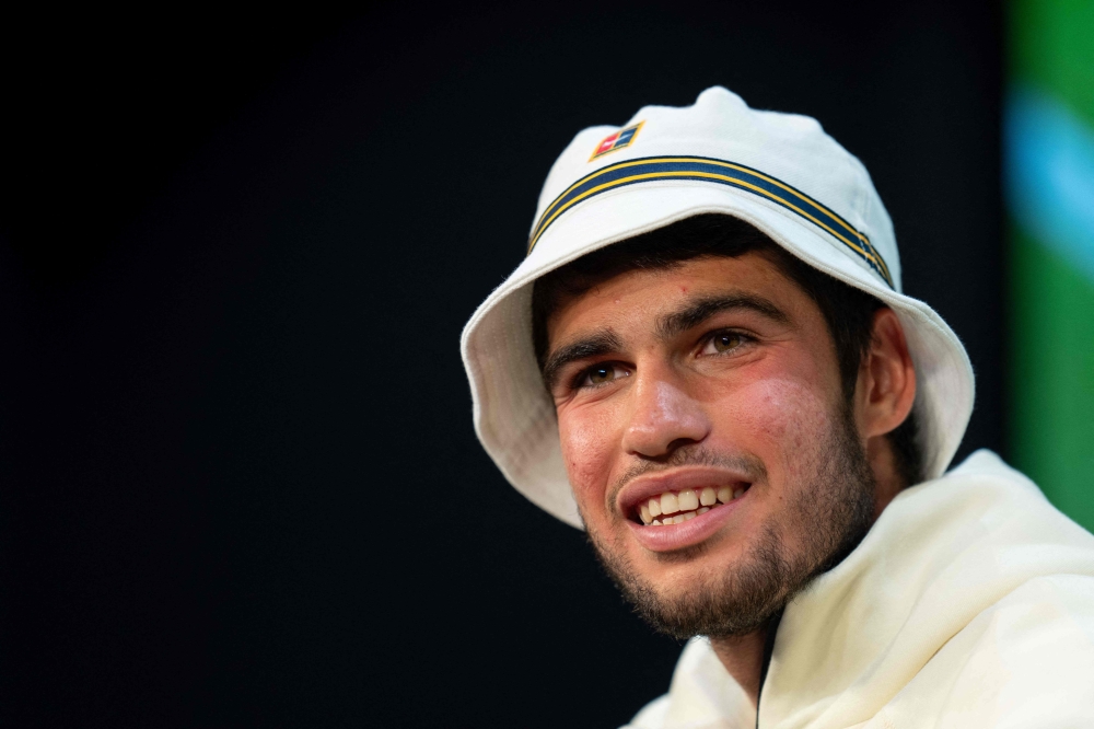 Spain's Carlos Alcaraz reacts as he speaks during a press conference in the Media Theatre at the Broadcast Centre following his victory in the men's singles final tennis match against Serbia's Novak Djokovic on the last day of the 2023 Wimbledon Championships at The All England Tennis Club in Wimbledon, southwest London, on July 16, 2023. Photo by Joe TOTH / various sources / AFP