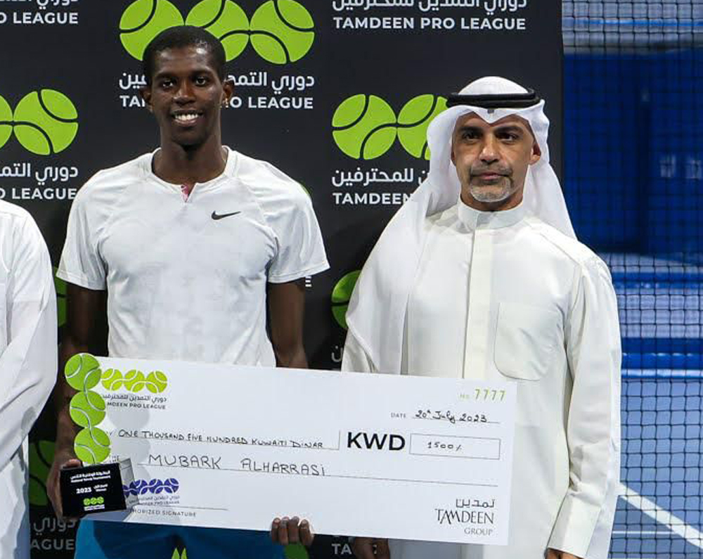 Qatar's Mubarak Shannan (left) holds the winner's prize after the Tamdeen Pro League final in Kuwait.