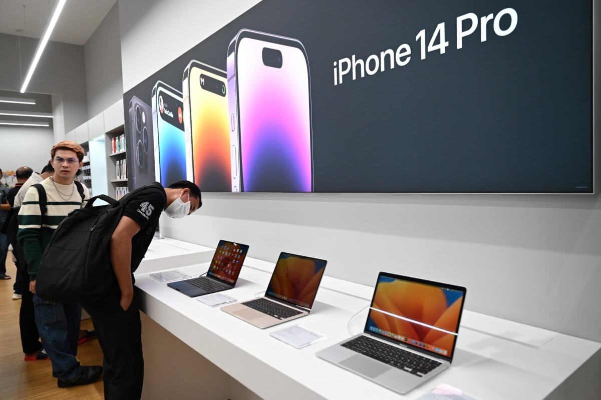 People look at MacBooks laptops during the first Apple Premium Reseller grand opening in Phnom Penh on July 15, 2023 (Photo by TANG CHHIN Sothy / AFP)