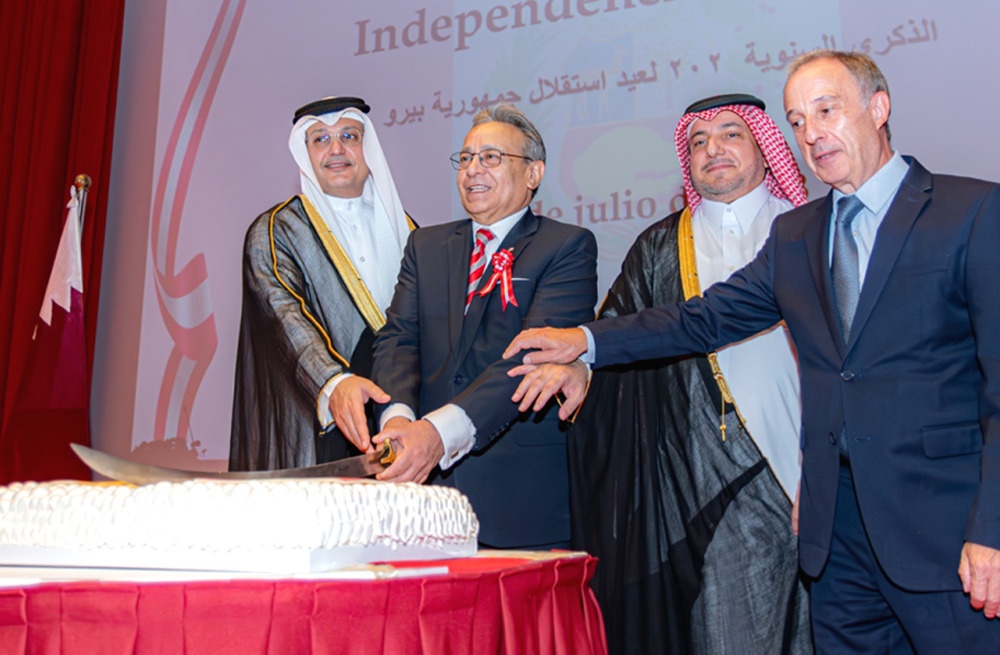 Minister of Communications and Information Technology H E Mohamed bin Ali Al Mannai (first left) and Ambassador of Peru to Qatar H E Jose A Benzaquen Perea (second left) along with other dignitaries cutting the ceremonial cake at the reception held to mark  202nd Anniversary of National Independence of Peru.