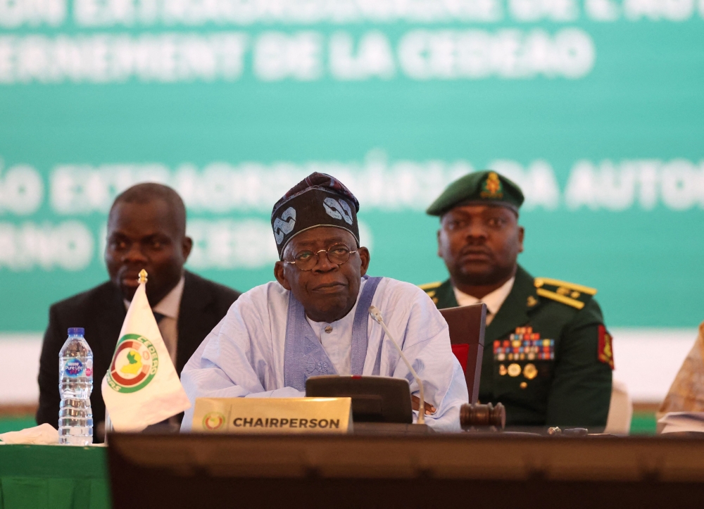 Chairperson of Economic Community of West African States (ECOWAS) and President of Nigeria, Bola Ahmed Tinubu, reacts while addressing the ECOWAS head of states and government, following Niger's military junta, in Abuja Nigeria on July 30, 2023 (Photo by Kola SULAIMON / AFP)