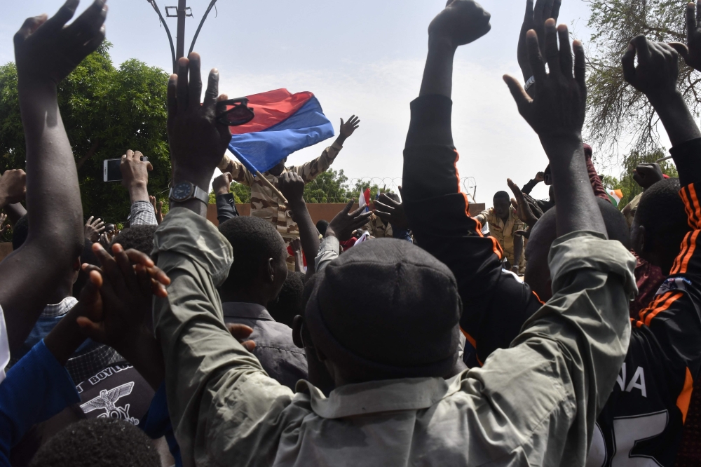 Protesters cheer Nigerien troops as they gather in front of the French Embassy in Niamey during a demonstration that followed a rally in support of Niger's junta in Niamey on July 30, 2023. (Photo by AFP)