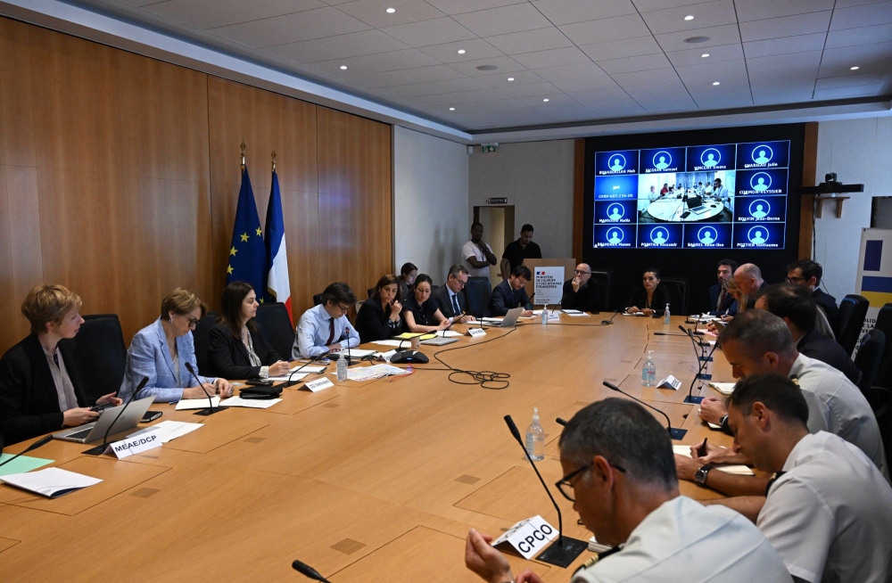 French Foreign and European Affairs Minister's cabinet director Luis Vassy (4th L) delivers a speech during a meeting on the ongoing situation in Niger following the coup, at the French Foreign and European Affairs Ministry in Paris on August 1, 2023. (Photo by STEFANO RELLANDINI / AFP)
