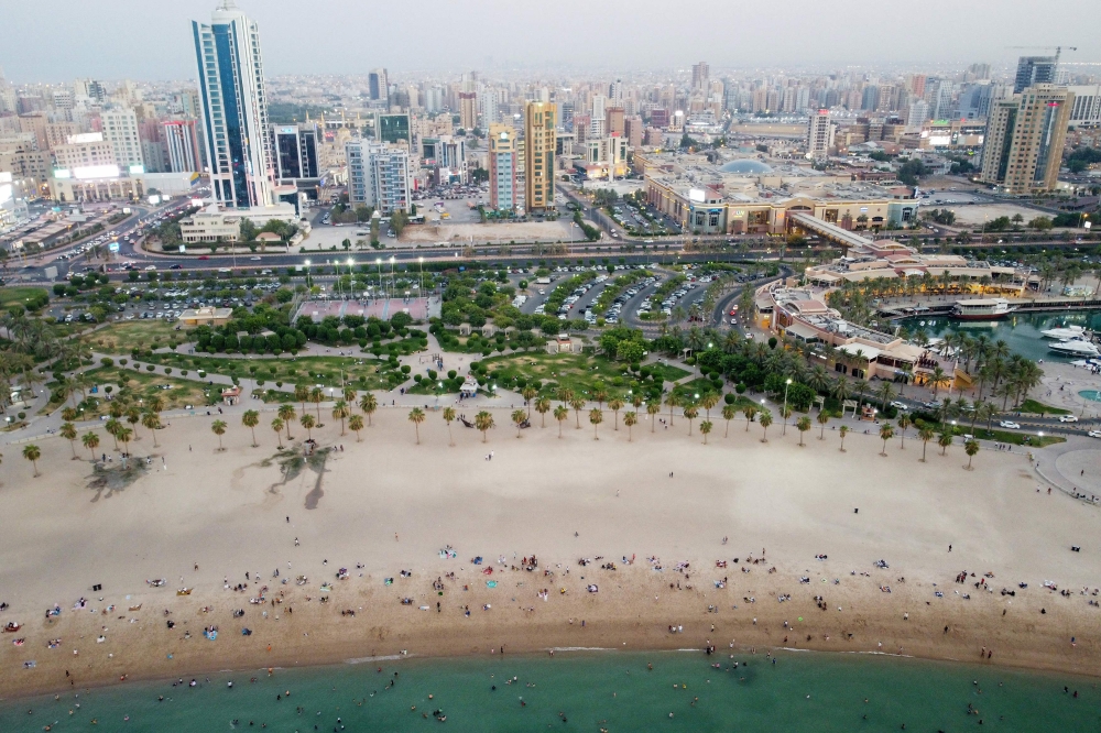 This aerial picture shows people at the beach to escape the heat in Kuwait City on July 7, 2023. (Photo by Yasser Al-Zayyat / AFP)