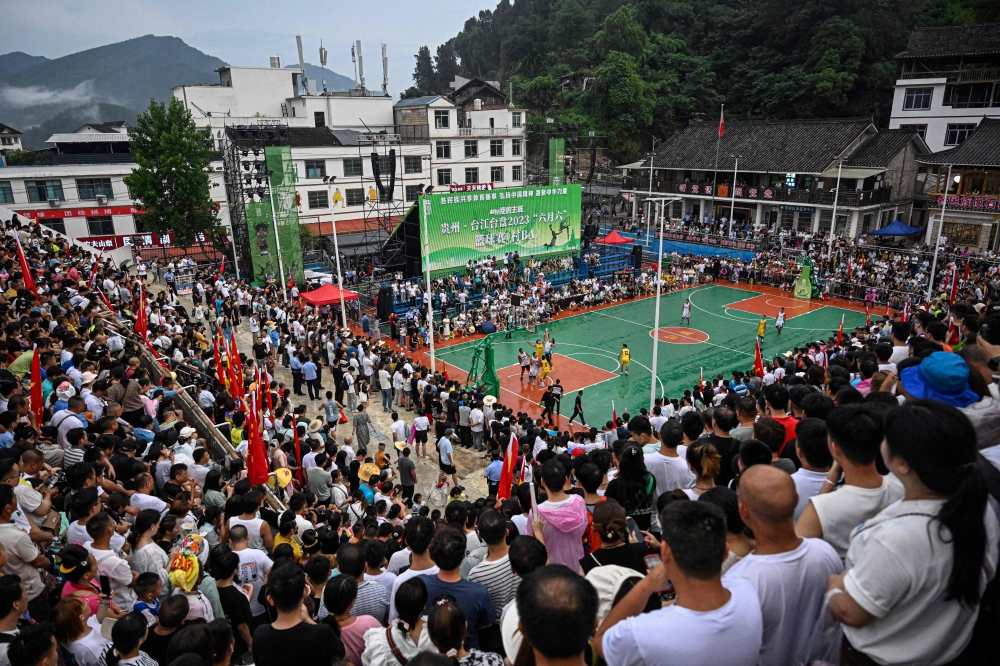 This photo taken on July 30, 2023 shows a general view of spectators watching a game of CunBA in Taipan village, Taijiang county, in southwestern China's Guizhou province. (Photo by Jade Gao / AFP)