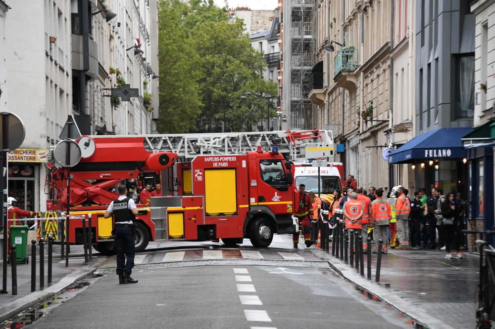 A firefighter vehicle leaves the area after a building collapsed due to an explosion on Rue Du Nord, in the 18th distrcit of Paris, on August 5, 2023. At least five people were injured in an explosion in a flat in the north of Paris. (Photo by Bertrand GUAY / AFP)
