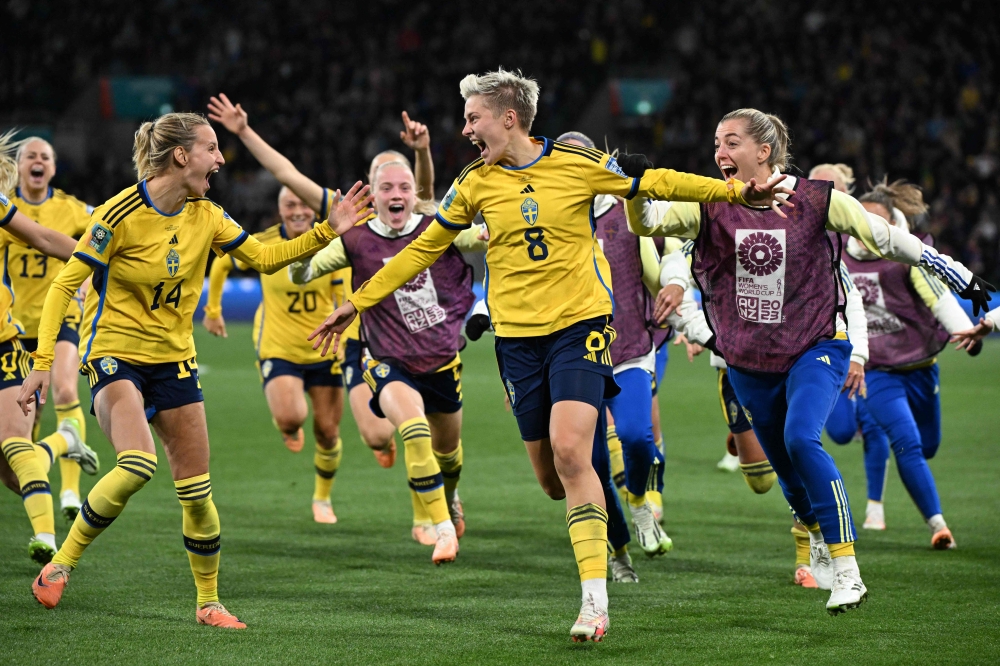 Sweden's forward #08 Lina Hurtig (C) and teammates celebrate their win at Melbourne Rectangular Stadium in Melbourne on August 6, 2023. (Photo by William West / AFP)