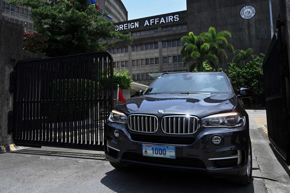 A Chinese diplomatic vehicle leaves the Philippine Department of Foreign Affairs in Manila on August 7, 2023. (Photo by JAM STA ROSA / AFP)