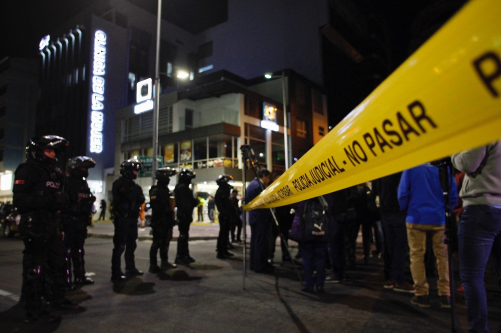 Policemen stand guard outside the hospital where presidential candidate Fernando Villavicencio was taken after being shot at a rally in Quito, on August 9, 2023. (Photo by Galo Paguay / AFP)