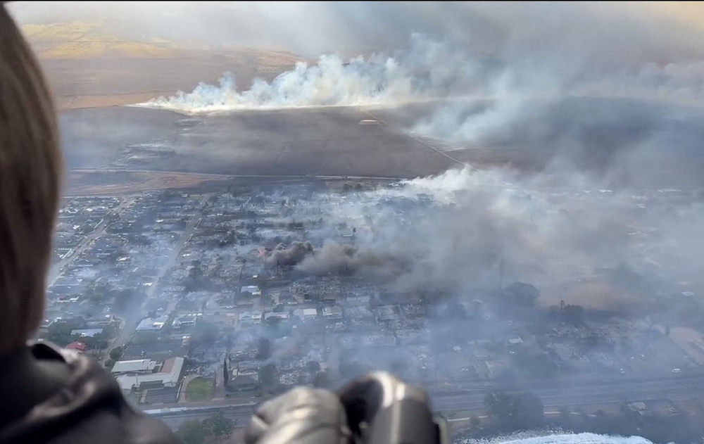 This handout video grab courtesy of Richard Olsten taken on August 9, 2023, shows smoke billowing from destroyed buildings as wildfires burn across Maui, Hawaii. (Photo by Richard Olsten / AFP)