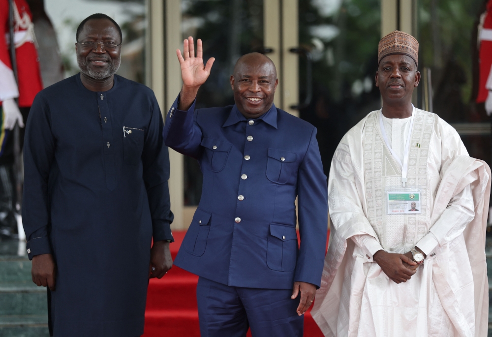 President of Economic Community of West African States Commission, Omar Touray (L), Burundi's President Evariste Ndayishme (C) and Nigeria's Ministry of Foreign Affairs, Adamu Ibrahim Lamuwa (R), pose for a photograph at the Economic Community of West African States (ECOWAS) Head of States and Government extraordinary session in Abuja, on August 10, 2023