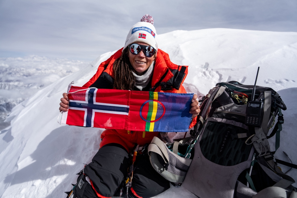 In this handout picture taken on April 26, 2023 by courtesy of Field Productions shows Norwegian climber Kristin Harila with her country flag at Shishapangma, 14th-highest mountain in the world, located in China. Photo by Handout / AFP
