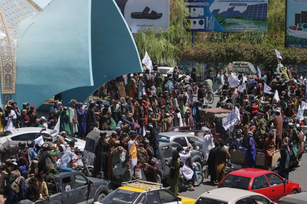 Taliban security personnel ride on vehicles as they celebrate the second anniversary of their takeover in Herat on August 15, 2023. (Photo by Mohsen Karimi / AFP)

