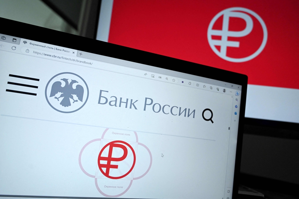 This photograph taken on August 15, 2023, shows the logo of a new Russian digital ruble displaying on the laptop screen in Moscow. (Photo by Sergei Gapon / AFP)

