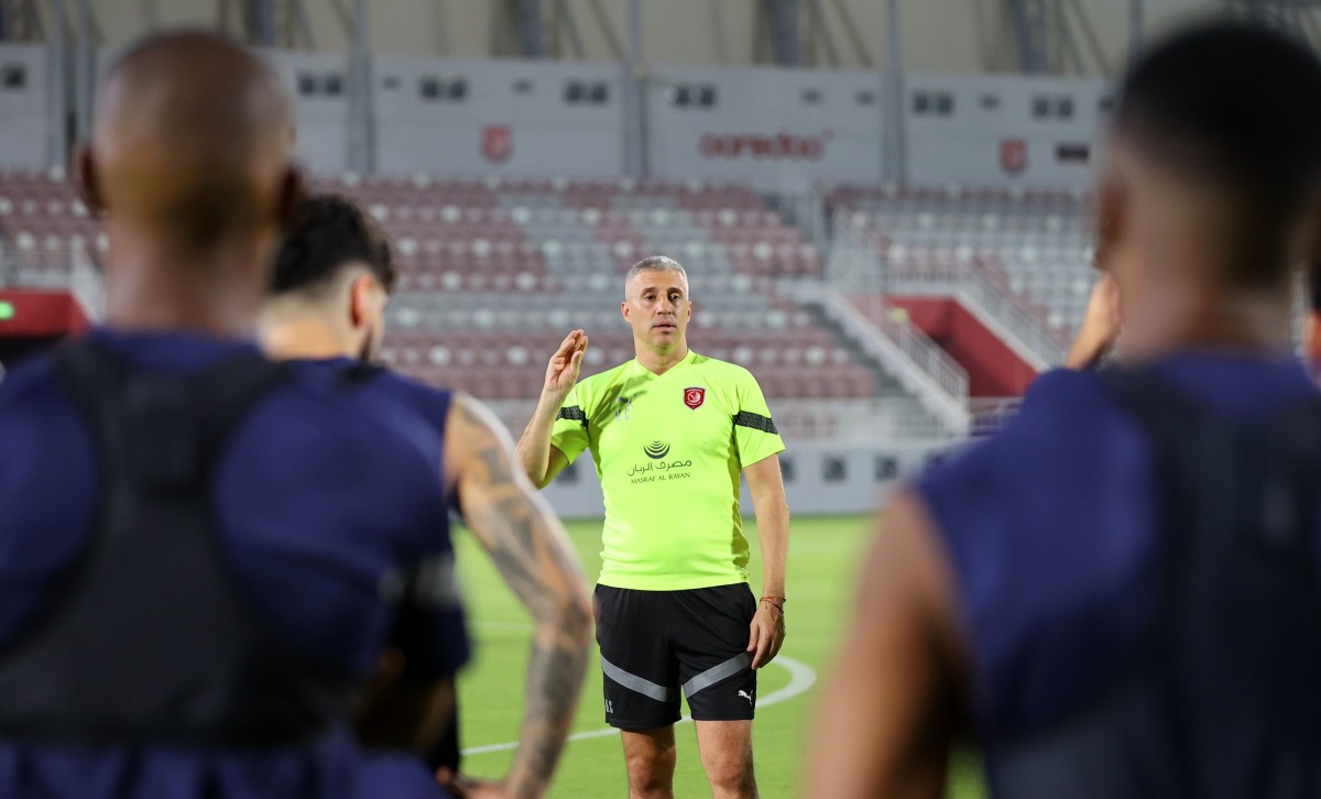 Al Duhail coach Hernan Crespo speaks to players during a training session.