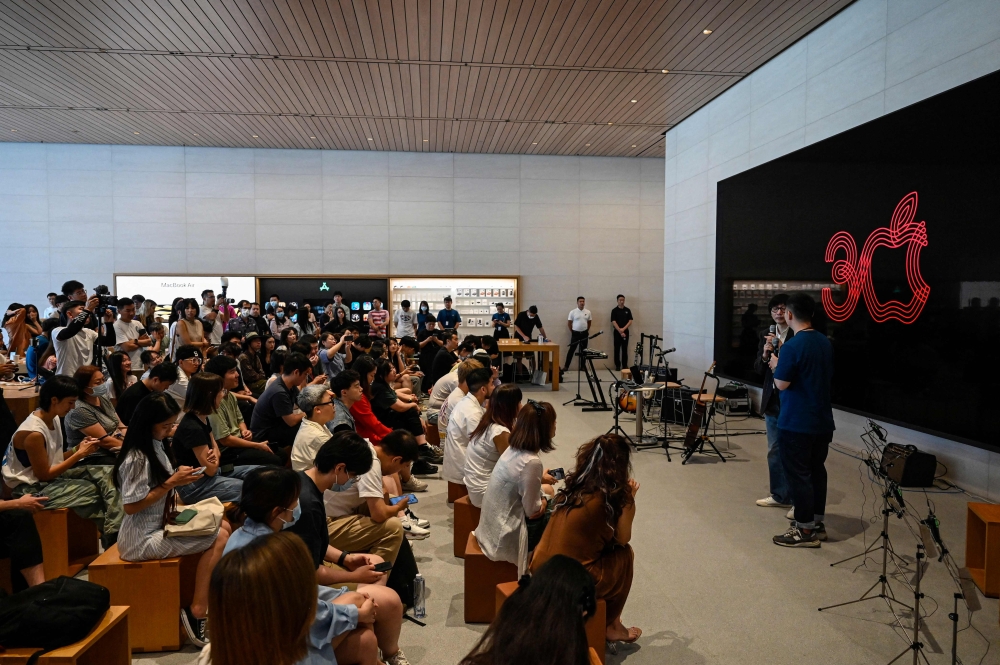 People attend an event celebrating Apple's 30th anniversary in China at an Apple retail store in Beijing on August 18, 2023. (Photo by Jade Gao / AFP)