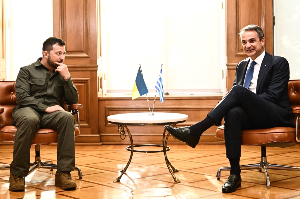 Greece's Prime Minister Kyriakos Mitsotakis (right) meets with Ukraine's President Volodymyr Zelensky at Maximou mansion in Athens, on August 21, 2023. (Photo by Angelos Tzortzinis / AFP)