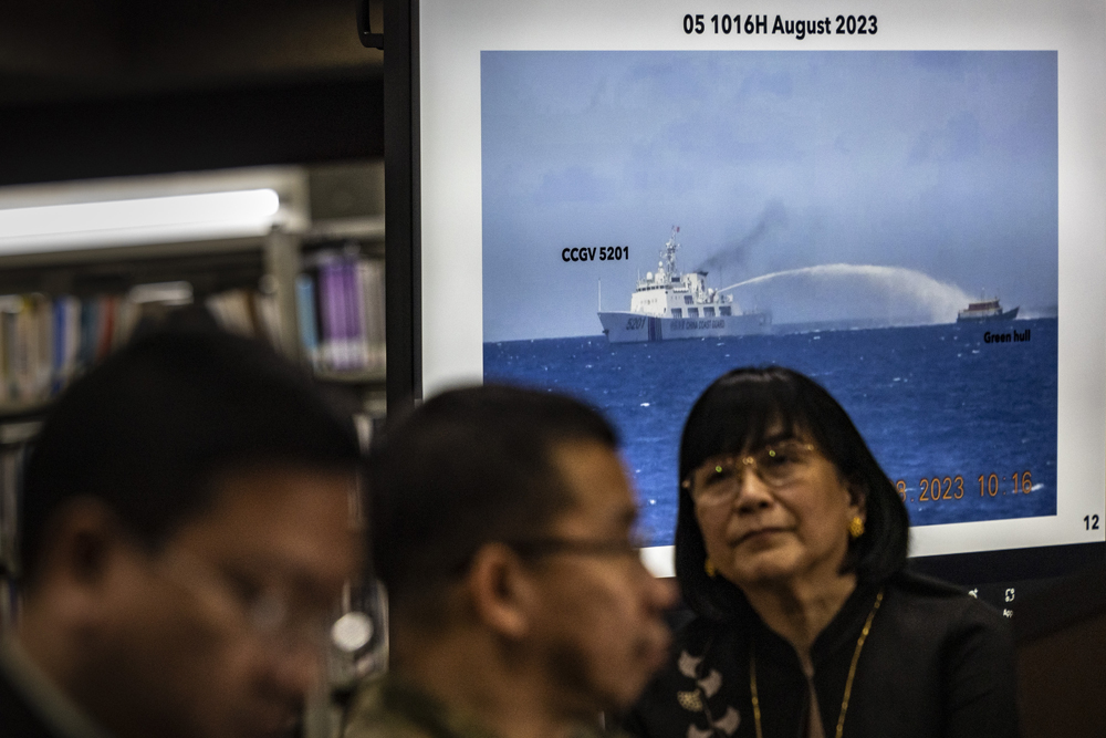 Footage of a Chinese Coast Guard ship using a water cannon against a Filipino resupply vessel is shown during a press conference at the Department of Foreign Affairs in Manila on August 7, 2023. Photo by Ezra Acayan / POOL / AFP

