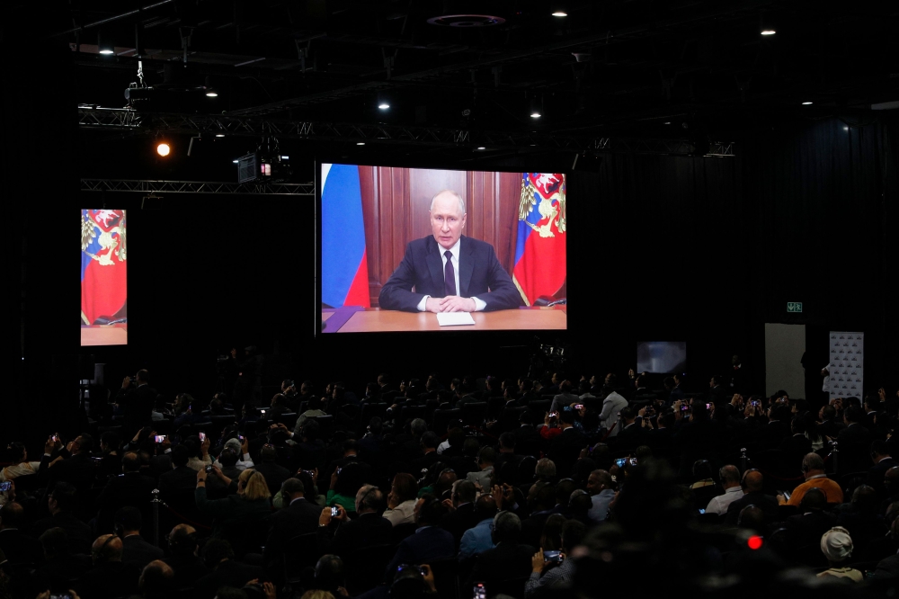 Russian President Vladimir Putin delivers his remarks virtually during the 2023 BRICS Summit at the Sandton Convention Centre in Johannesburg on August 22, 2023. (Photo by GIANLUIGI GUERCIA / AFP)
