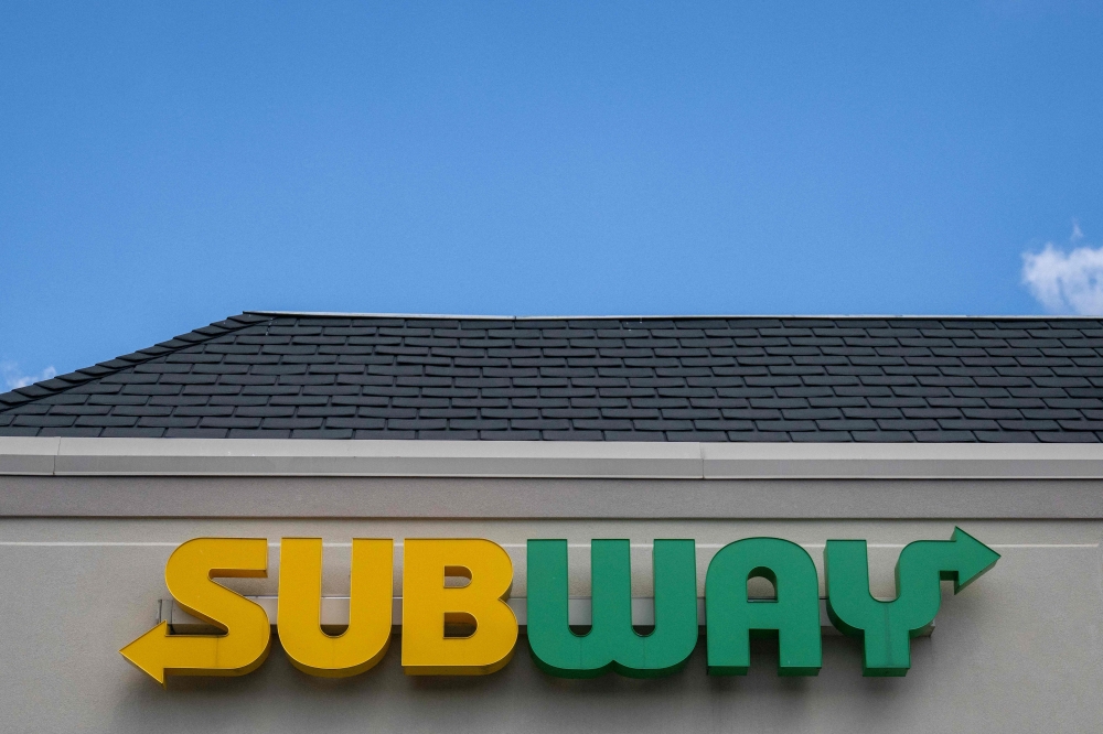 The Subway sign hangs over the sandwich shop in Annapolis, Maryland, on August 23, 2023. The Subway sandwich chain is near a deal to be acquired for more than $9 billion in a transaction that could be announced as soon as August 23, 2023, a person familiar with the matter said. (Photo by Jim WATSON / AFP)
