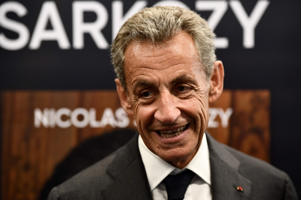 Former French President Nicolas Sarkozy reacts during a book signing session for his last book, in Arcachon, southwestern France, on August 25, 2023. (Photo by Christophe ARCHAMBAULT / AFP)
