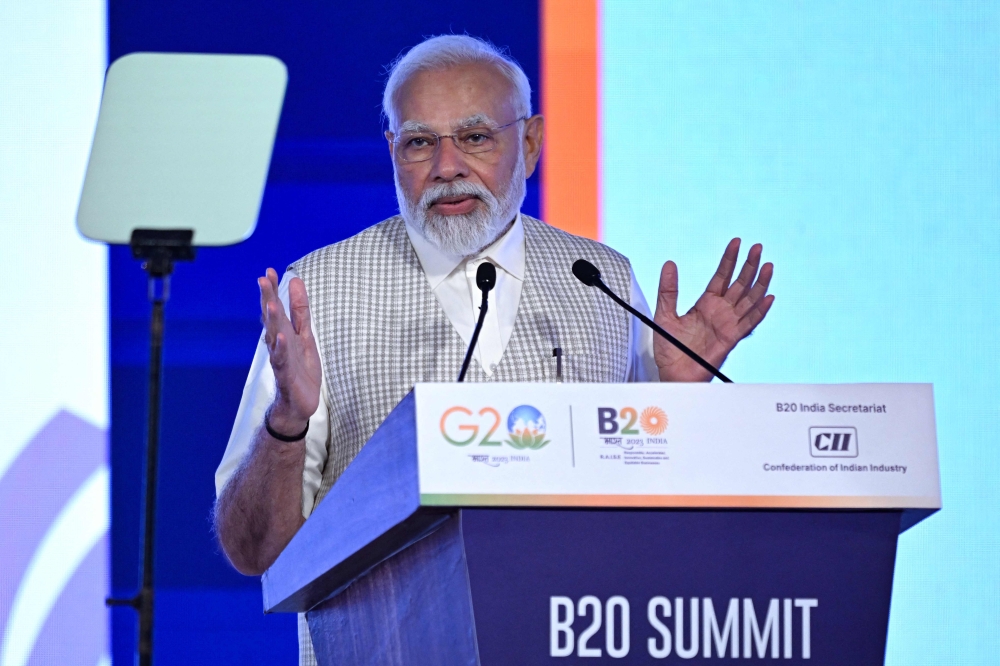 India's Prime Minister Narendra Modi speaks during the third day of the three-day B20 Summit in New Delhi on August 27, 2023. (Photo by Sajjad Hussain / AFP)