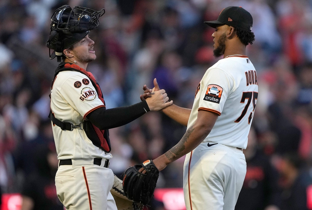 Patrick Bailey #14 and Camilo Doval #75 of the San Francisco Giants celebrate defeating the Atlanta Braves 8-5 at Oracle Park on August 27, 2023 in San Francisco, California. (Photo by Thearon W. Henderson / GETTY IMAGES NORTH AMERICA / Getty Images via AFP)