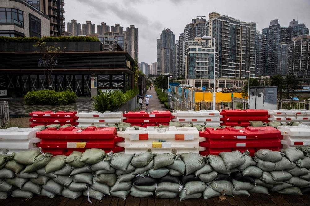 Sand bags are placed to stop flooding by the waterfront at Tseung Kwan O in Hong Kong on September 1, 2023, ahead of the expected arrival of Super Typhoon Saola. Photo by ISAAC LAWRENCE / AFP