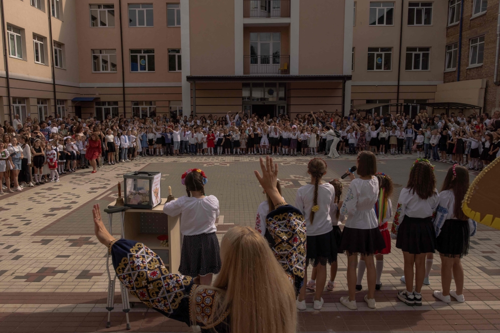 Pupils gather with their relatives and teachers for a ceremony to mark the start of the new school year, known as the 'Day of Knowledge' in Irpin, northwest of Kyiv, on September 1, 2023, amid the Russian invasion of Ukraine. Photo by Roman Pilipey / AFP