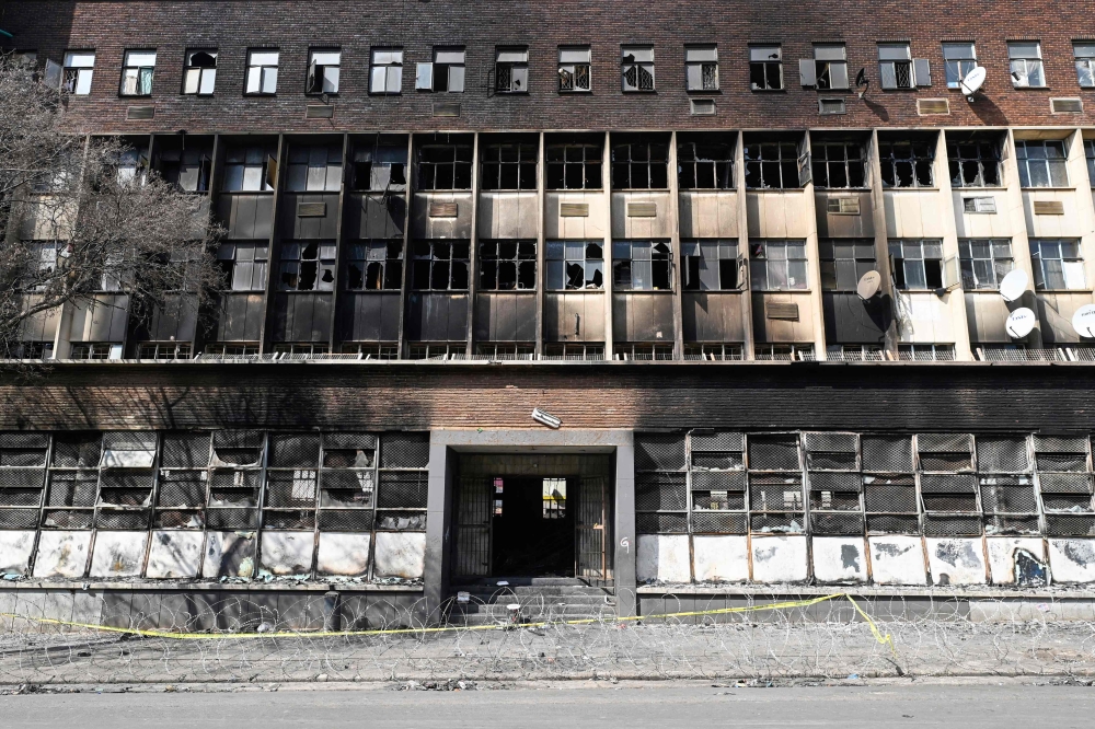 A general view of a burned apartment block in Johannesburg on September 1, 2023. (Photo by Luca Sola / AFP)