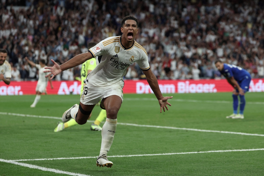 Real Madrid's English midfielder #5 Jude Bellingham celebrates after scoring his team's second goal during the Spanish Liga football match between Real Madrid CF and Getafe CF at the Santiago Bernabeu stadium in Madrid on September 2, 2023. (Photo by Thomas COEX / AFP)