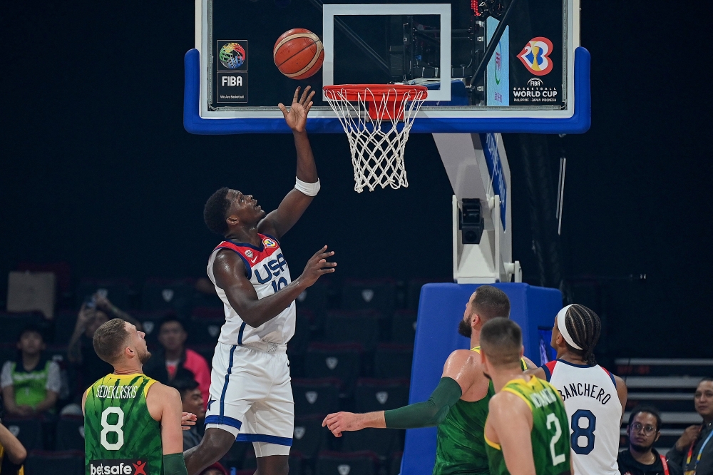 USA Anthony Edwards ( 2nd L) shoots the ball during the FIBA Basketball World Cup second round match between USA and Lithuania at Mall of Asia Arena in Pasay City, suburban Manila on September 3, 2023. (Photo by JAM STA ROSA / AFP)