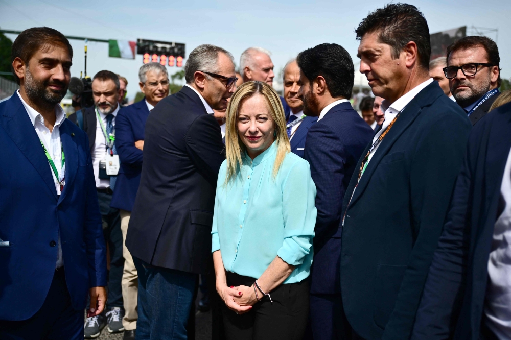 Italian Prime Minister Giorgia Meloni (centre) looks on prior to the start of the Italian Formula One Grand Prix race at Autodromo Nazionale Monza circuit, in Monza on September 3, 2023. (Photo by Marco Bertorello / AFP)
