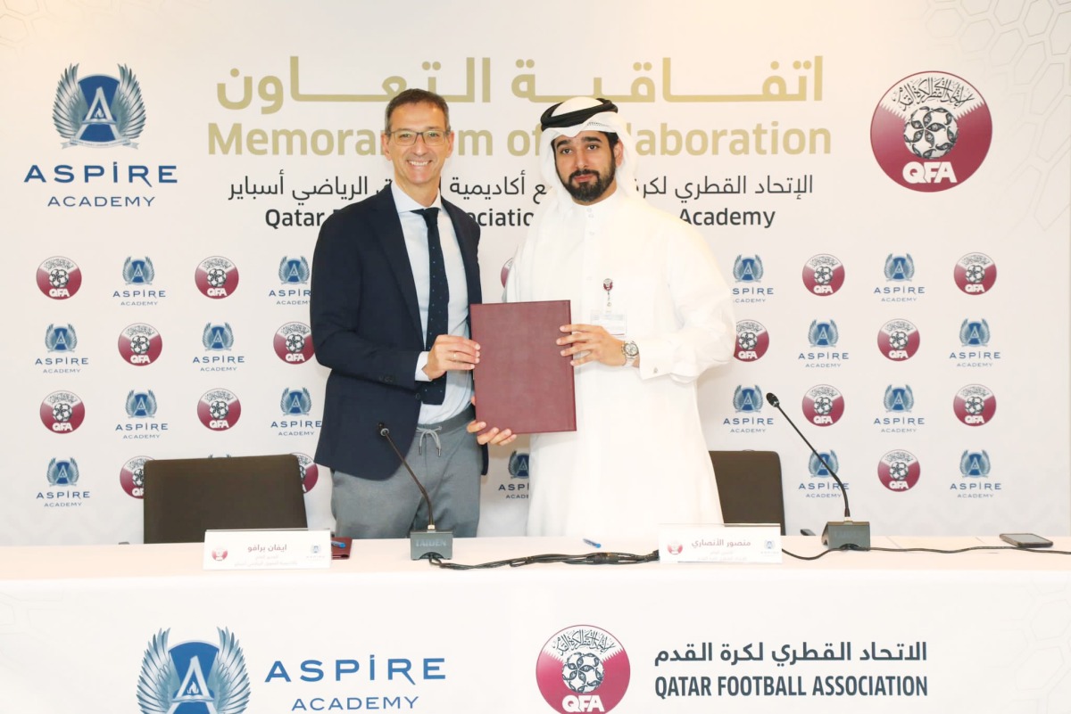 QFA Secretary General Mansour Al Ansari and Director General of the Aspire Academy Ivan Bravo pose for a photo after the signing ceremony. 
