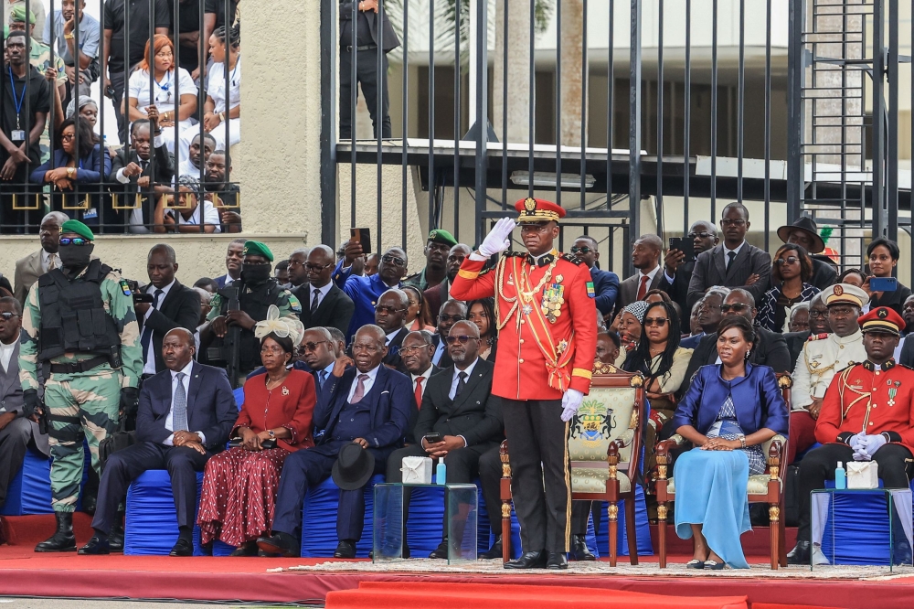General Brice Oligui Nguema (centre), who was inaugurated as Gabon's interim President, gives a salute during the military parade in Libreville on September 4, 2023. (Photo by AFP) 