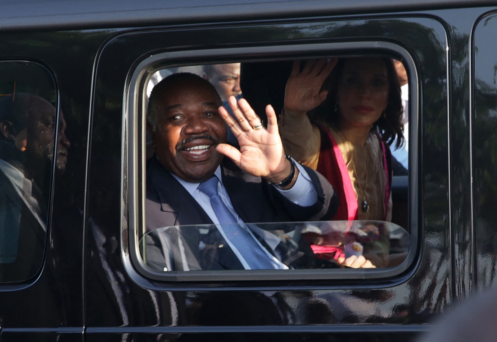 File photo: Gabonese President Ali Bongo Ondimba waves from his car upon his arrival in Libreville on March 23, 2019. (Photo by Steeve Jordan / AFP)